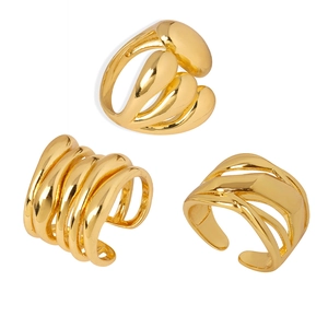 Three gold geometric rings with multi-layer wave designs and polished liquid metal finish