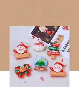 Macro shot of 3D Christmas resin charms including Santa Claus and reindeer for DIY crafts
