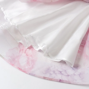 Detail van de gelaagde zoom met roze bloemen organza en witte satijnen voering