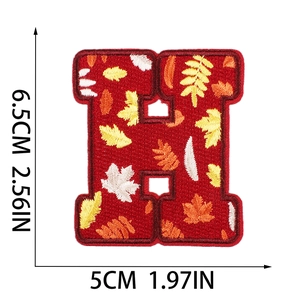 Detailed size view of embroidered letter H patch featuring autumn leaves in 6.5cm x 5cm