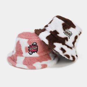 Winter plush bucket hats with cow print and embroidered patches in pink and brown