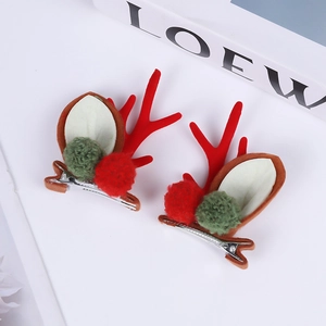 Detailed close-up of Christmas reindeer antler hair clips with red horns and bells