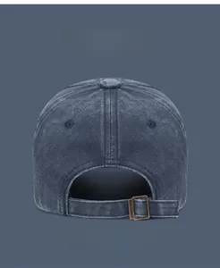 Detail view of washed cotton baseball cap featuring a premium metal adjustable buckle