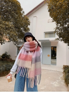 Close-up of rainbow plaid scarf with long fringes featuring pink and purple pastel colors