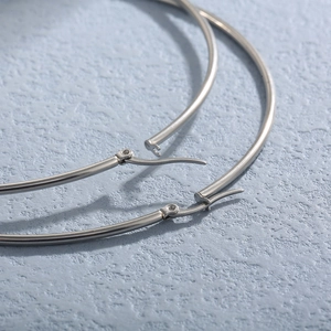 Minimalist silver stainless steel hoop earrings with high-polish metallic finish for women