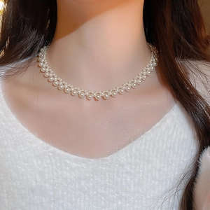 Close-up of double-layer pearl necklace on model neck with elegant vintage style