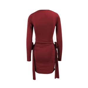 Detail view of red off-shoulder mini dress featuring back ruching and side bow ties