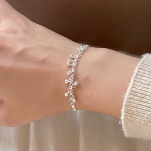 Close-up of minimalist 925 sterling silver beaded bracelet worn on a female wrist