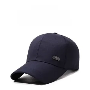 Detail of navy blue cotton baseball cap featuring a metal plate with classic engraving