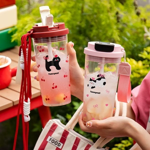 Outdoor lifestyle shot of portable plastic water cups with cat prints and colorful straps