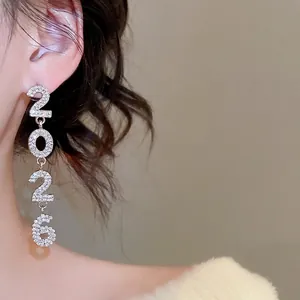 Sparkling silver 2026 tassel earrings with rhinestones shown on model for elegant style