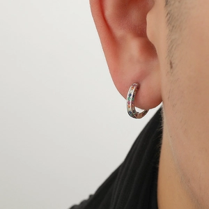 Rainbow huggie earrings with colorful cubic zirconia stones on silver base worn by model