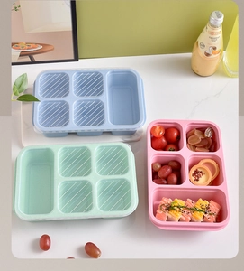 Overhead view of five-compartment wheat straw lunch boxes in blue, green, and pink