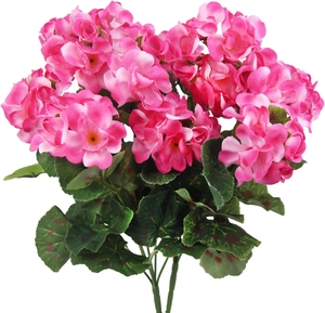 Detail of artificial pink geranium silk flowers with realistic green leaves on white background