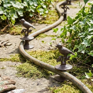 Vintage cast iron bird garden hose guide stakes for lawn and backyard decoration