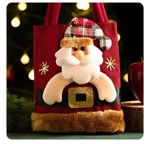 Detail of red burlap Christmas gift bag with plush Santa Claus and sequin snowflakes