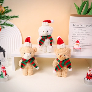 Close-up of cute plush Christmas teddy bears with knitted hats and striped scarves