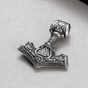 Macro shot of Viking Mjölnir hammer pendant with Valknut symbols and embossed details