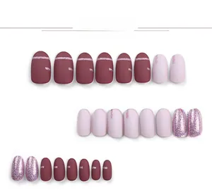 Detail view of round press-on nails in matte burgundy, pink, and glitter finishes