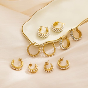 French vintage gold pearl hoop earrings and stud set displayed on a ceramic tray