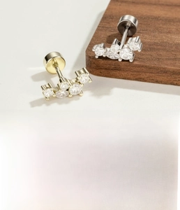 Detail view of marquise zircon ear studs in silver and gold with size specifications