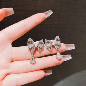 Elegant bow earrings with sparkling crystals, pearls, and water-drop pendants