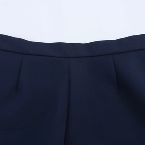 Detailed close-up showing the waistline stitching and fabric of this navy blue A-line skirt