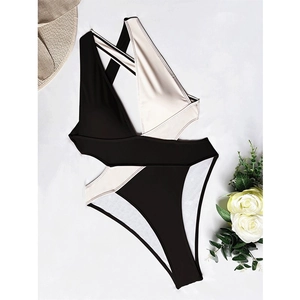 Elegant cutout one-piece swimsuit in black and white contrast with a cross halter neck