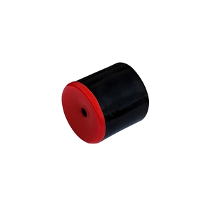 Macro view of the black Le Tooter prank toy cylinder with red cap and center hole