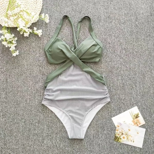 Detailed flat lay of olive green halter neck swimsuit with black and white striped pattern