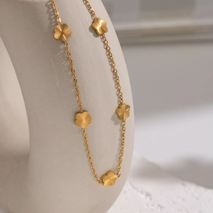Elegant 18K gold plated stainless steel necklace featuring multiple small floral pendants