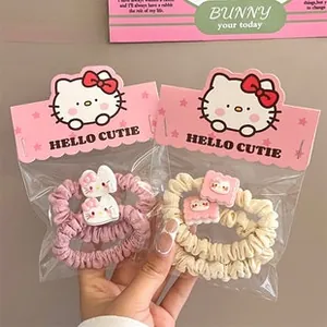 Detail of Hello Kitty hair scrunchies set in pink and beige with cute resin charms