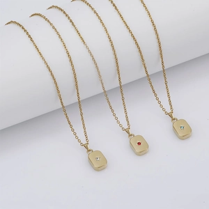 Three gold rectangle necklaces with inlaid white, red and blue zircons on white background