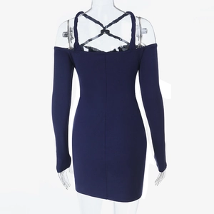 Rear view of slimming dark blue mini dress featuring crossover halter and long sleeves