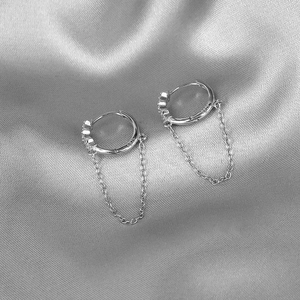 Macro view of S925 sterling silver star hoop earring with delicate chain and zircon