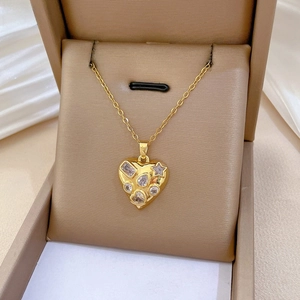 Detailed macro of gold heart pendant with multi-cut sparkling crystals on jewelry box