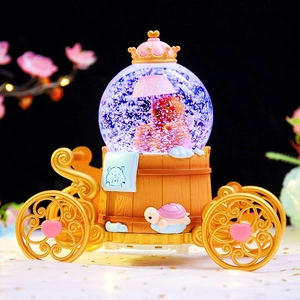 Golden carriage capybara crystal ball music box with crown and bear decor in glowing snow