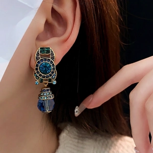 Vintage gold-tone earrings with blue crystals and green gemstones in baroque style