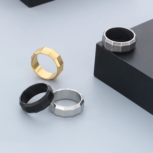 Detailed view of 8mm faceted minimalist stainless steel rings in four metal colors