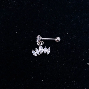 Macro shot of silver crown pendant stud earrings with sparkling cubic zirconia on black velvet