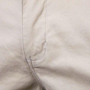Close-up of khaki cotton shorts showing premium double-stitched seams and twill fabric