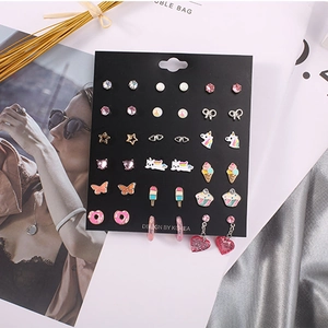 Colorful kids earring set with unicorn and star shapes on black display card