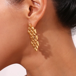 Close-up of 18K gold-plated stainless steel earrings with watchband chain link texture