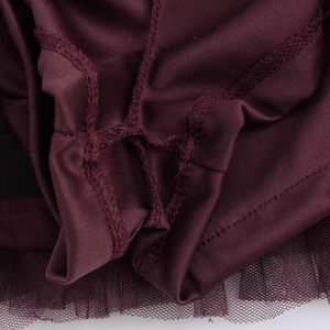 Close-up of deep red knitted fabric joined with mesh tulle using double needle stitching