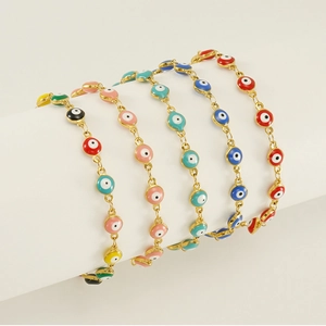 Detailed macro view of colorful evil eye bracelets with gold finish and enamel accents
