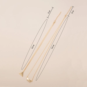 Detail showing two gold geometric pyramid necklaces with adjustable 42cm and 54cm chains