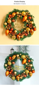 Detail of Christmas wreath with pine cones and golden Merry Christmas sign decoration