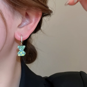 Détail de la boucle d'oreille ours en résine irisée verte avec anneau en zircon