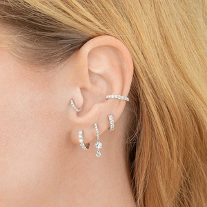 S925 silver hoop earrings set with zircon stones layered on a female model