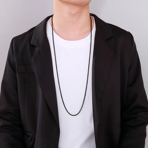 Close-up of long black titanium steel chain necklace on a male model with blazer